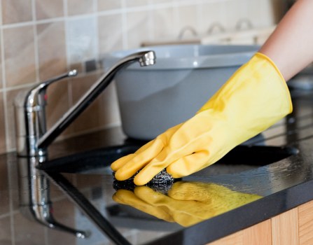 Professional cleaner working in a Paddington home living room